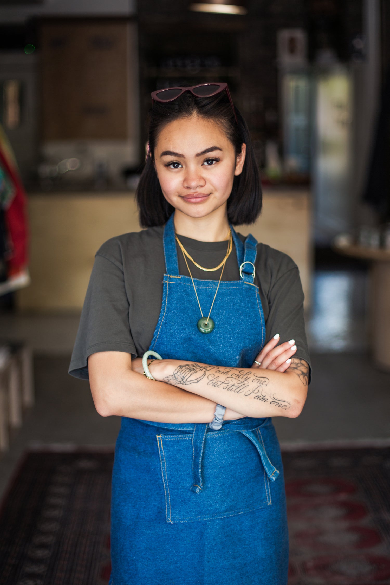 young-woman-stands-at-front-of-her-retail-store-moku-website-design-hawaii